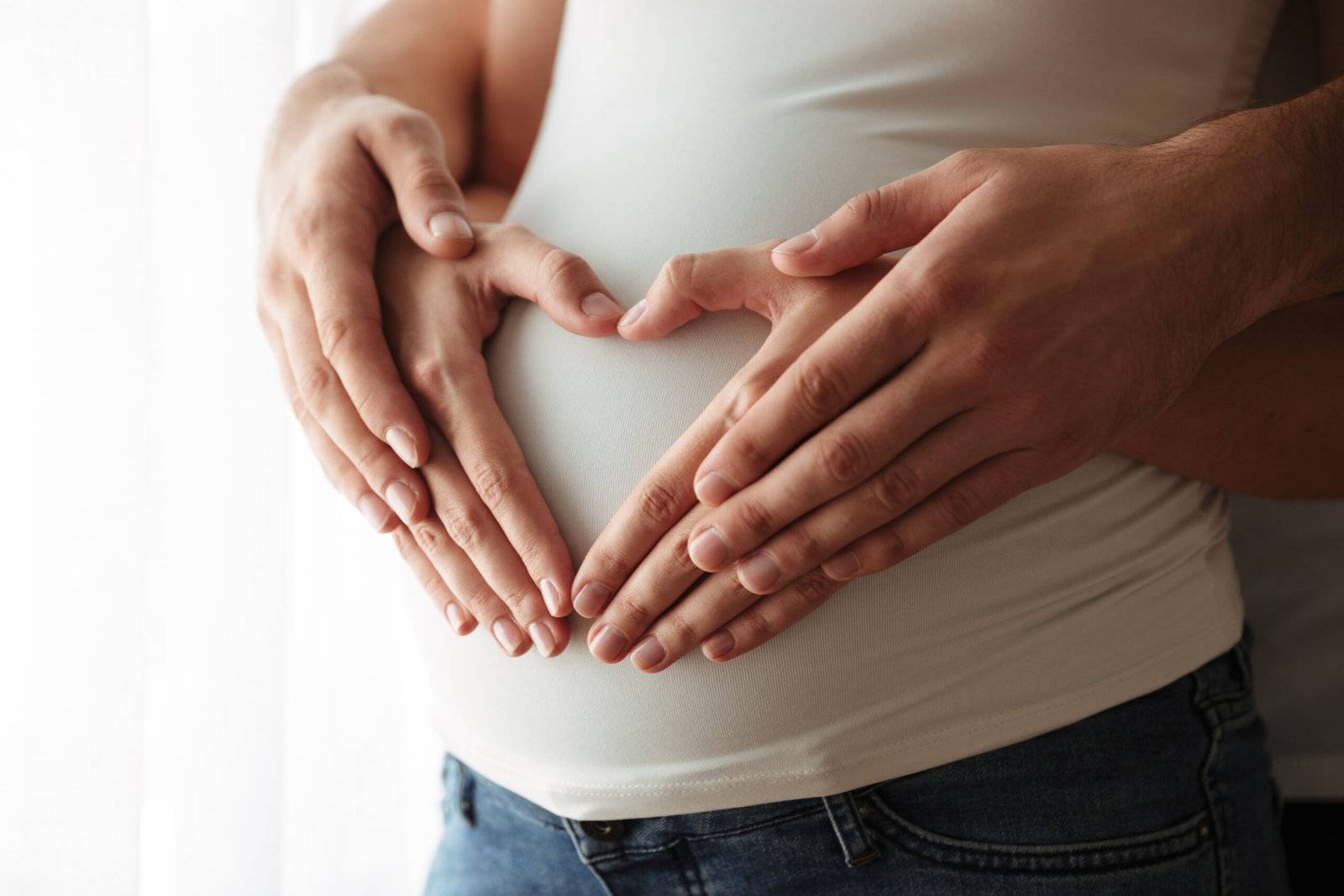 hands holding pregnant mom