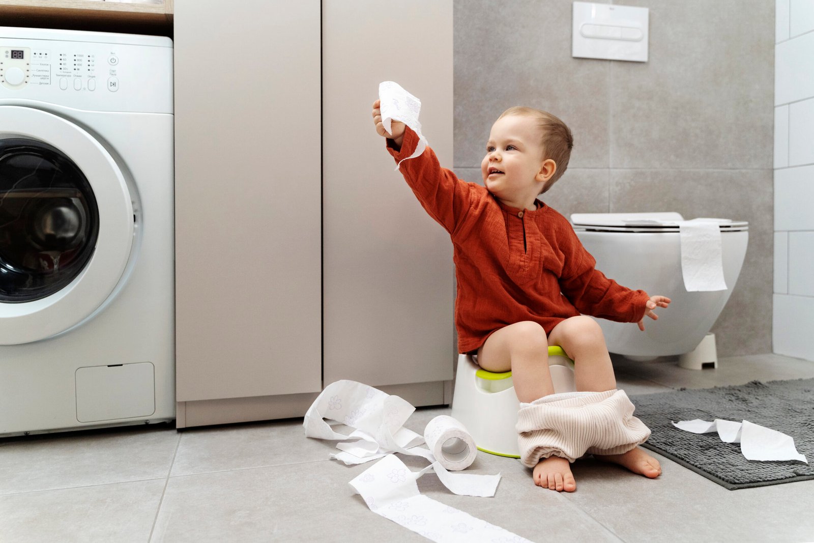 Baby sitting on toilet